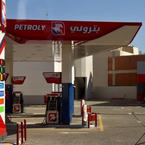 Modern petrol station forecourt with fuel pumps under a clear sky