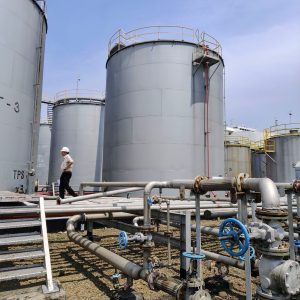 Petroleum storage tanks, pipelines and an operator at an industrial fuel facility